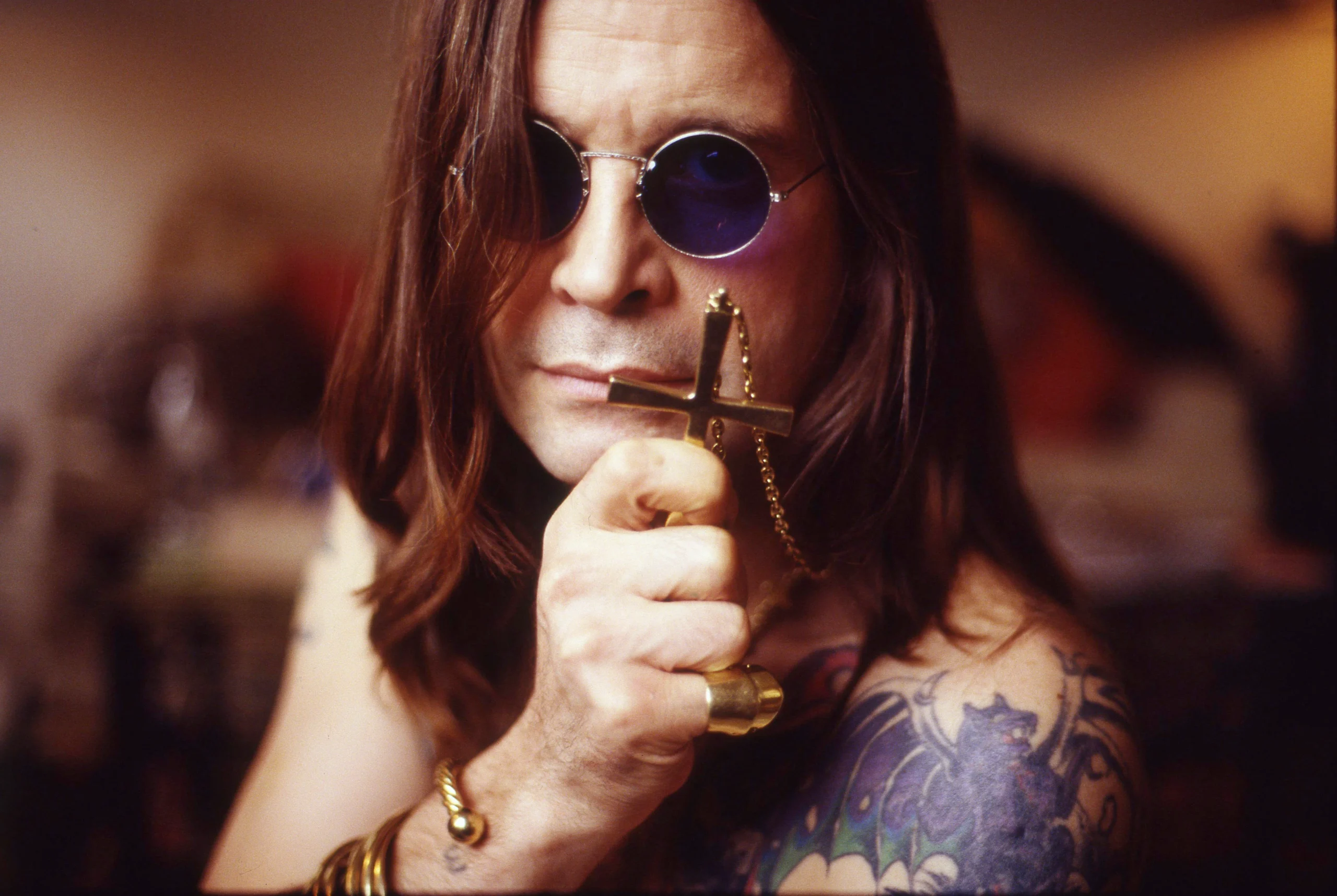 ozzy osbourne holding a cross